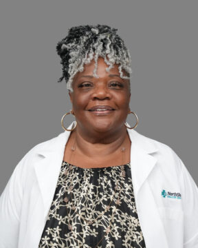 Charae Bland, LSW, smiling in her NorthShore Health Centers white coat.