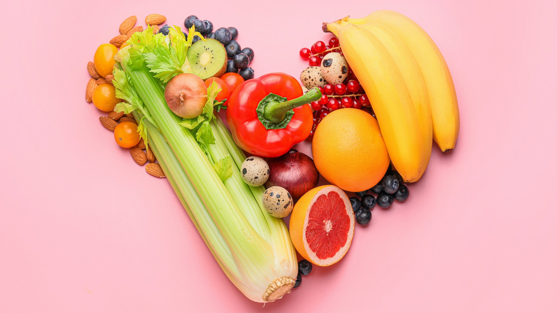 Bright, colorful produce including red peppers, bananas, grapefruit, and berries to support heart-healthy diets.