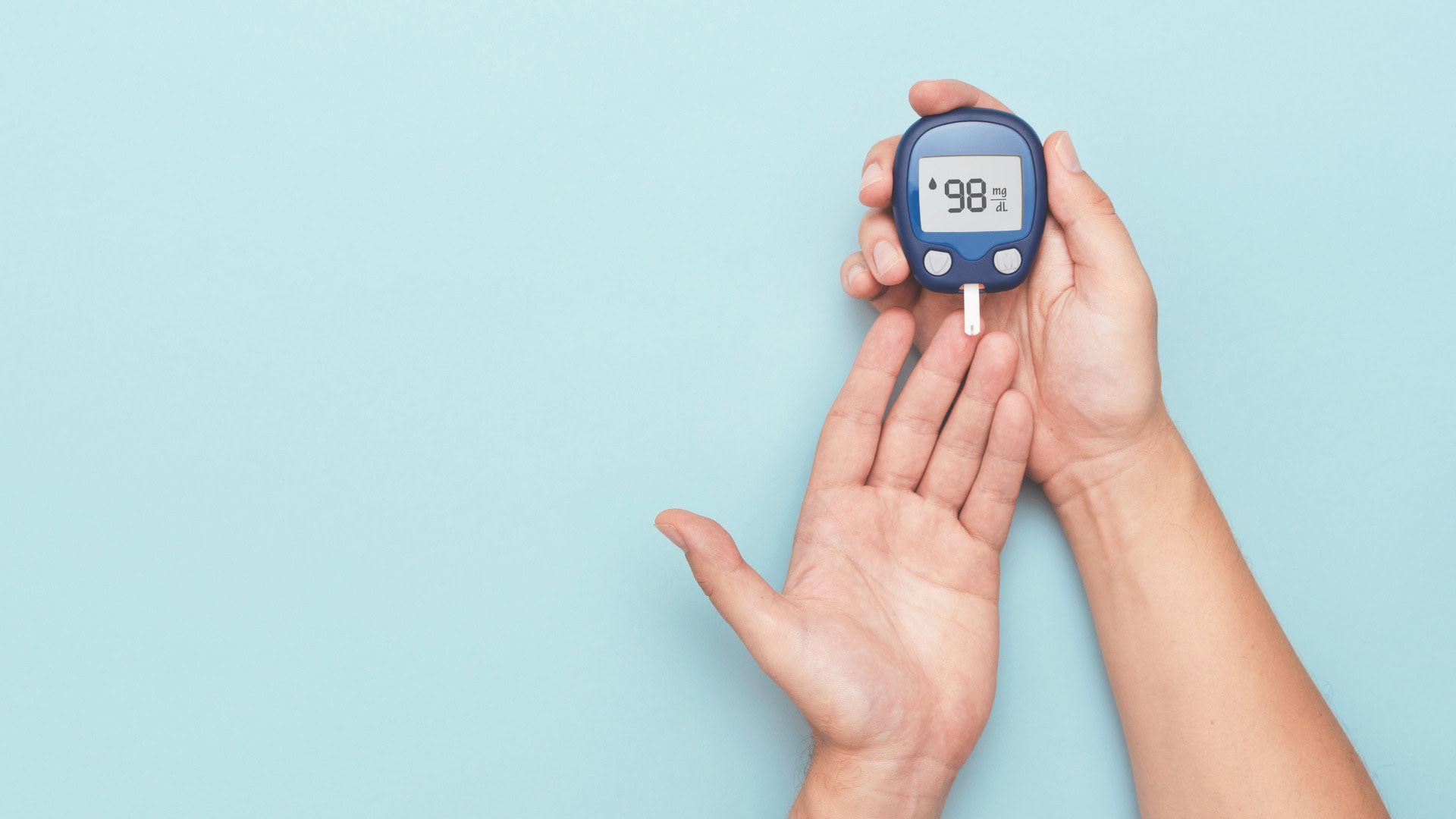 Blood glucose meter showing 98 mg/dL for diabetes monitoring, essential for diabetes care and control.